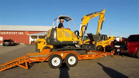 mini excavation loaded in a pickup truck|mini on flatbed truck.